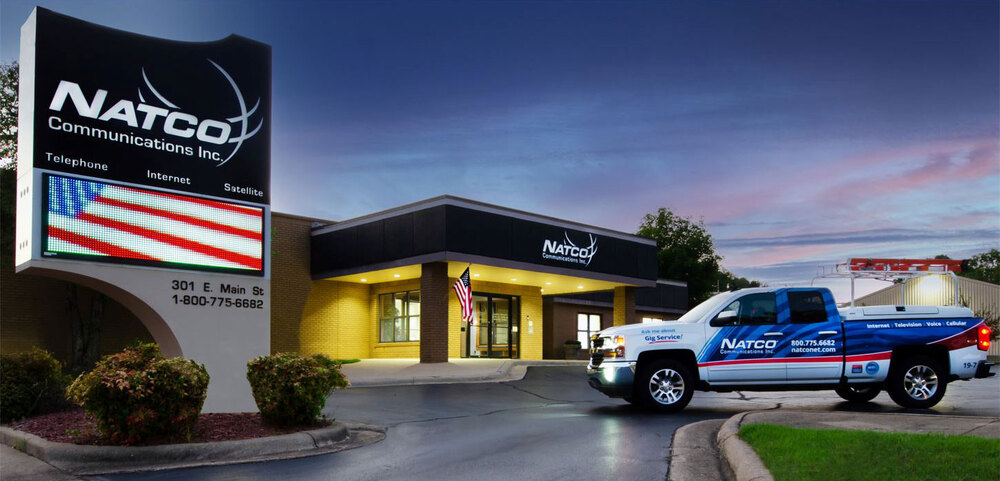 NATCO Sign, Office Building and Truck at dusk